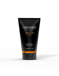 A scenic image depicts steep, rugged cliffs towering beside a deep turquoise sea, evoking the invigorating sensation of Wicked Jelle Heat Warming Anal Gel 4oz. The clear sky enhances the vivid colors, while lush greenery on the cliff edges adds a touch of