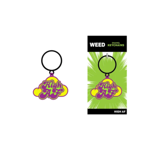 The Wood Rocket-High AF Keychain showcases vibrant purple and yellow text on a cloud-shaped design. It elegantly hangs beside its packaging, which is adorned in green with white rays and prominently branded as WEED Enamel Keychains—an ideal accessory for 