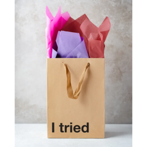 The Wood Rocket-I Tried Bag, featuring a beige design with brown handles, humorously showcases the text 