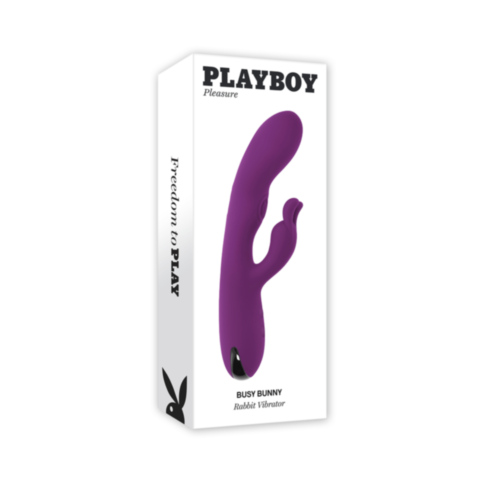 The Evolved-Playboy Sil Recharge Busy Bunny-Wild Aster, a purple rabbit vibrator designed for G-Spot stimulation and made from body-safe silicone, is enclosed in a white box featuring the Playboy logo. The packaging prominently highlights the slogan "Free