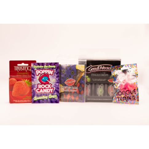 The Curated Kit by Starship - Kissable Oral Kit features a vibrant display of colorful candy and flavoring products, including Trustex Lub Strawberry Condom, Poppin Rock Candy, Trustex banana flavor, GoodHead Tingle Drops, and edible tongue tattoo candy.