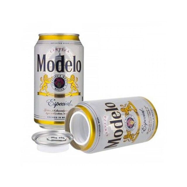 A green background with a light gray rocket icon encircled by stars captures the refreshing essence of a classic Mexican pilsner beer. Above, in bold light gray font, is the text Modelo Beer 12oz Can Safe, reminiscent of the subtle sweetness found in oran