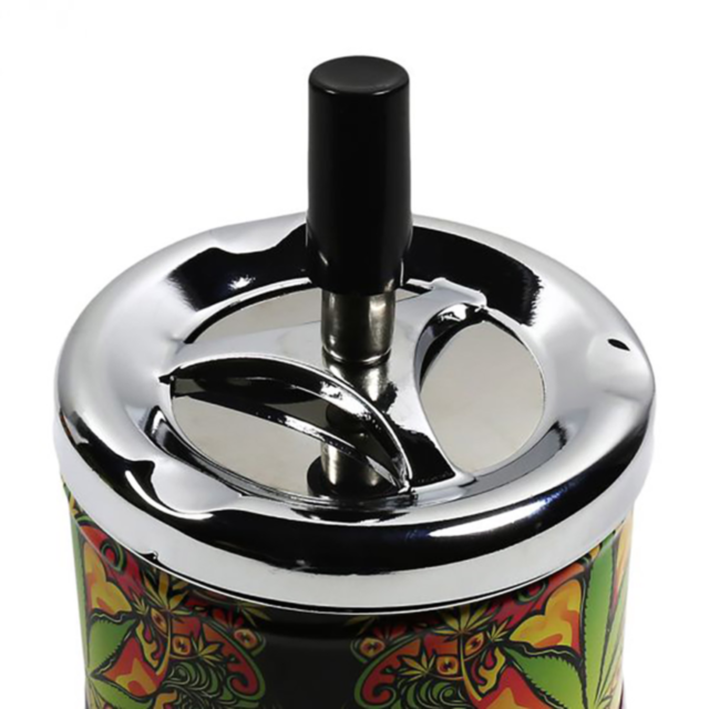 Green graphic showcasing the text "Spinning Asst. Leaf Images Ashtrays" above a white rocket encircled and surrounded by stars, highlighted by an assorted leaf design motif.