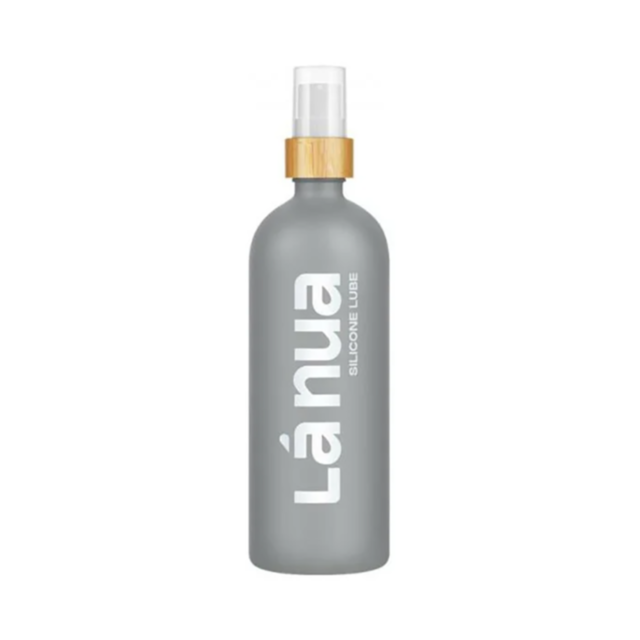 Grey bottle of Lá Nua Unscented Silicone Lubricant-6.8oz with a clear pump, wooden cap, and vertically printed brand name in white, offers a natural moisturizer experience.