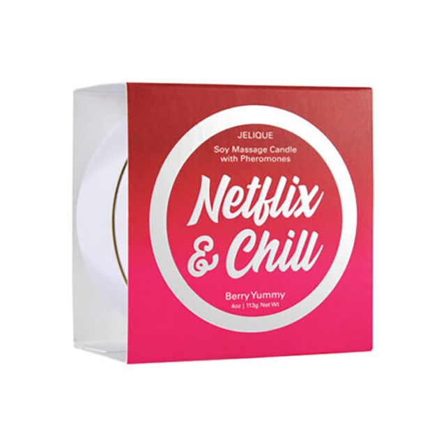A vibrant pink flower with delicate petals is in bloom, encircled by verdant green leaves. The sun bathes the flower in a gentle light, intensifying its vivid hue just as a Massage Candle with Pheromones Netflix and Chill Berry Yummy enhances relaxation, 