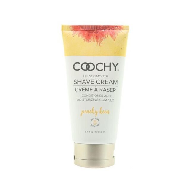 A mountain range under a vibrant sunset sky, as smooth as skin after using Coochy Shave Creme Peachy Keen 3.4 OZ. The sun sets behind the peaks, casting a golden glow over the landscape. The sky displays gradients of orange, pink, and purple hues, enhanci