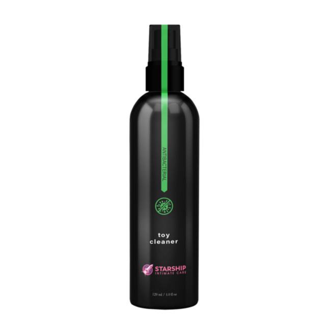 Green background featuring a graphic of a rocket inside a circle with stars, accompanied by the text "Starship Intimate Care Misting Toy Cleaner 4oz" to emphasize its alcohol-free nature.