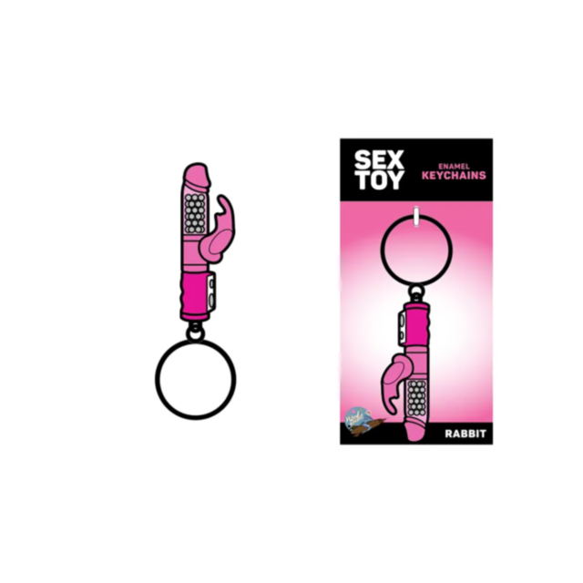 This unique accessory, the Wood Rocket-Rabbit Keychain, is designed in the shape of a pink rabbit vibrator and comes packaged in a playful box. The packaging vividly displays "Sex Toy Enamel Keychains Rabbit" on a striking pink background.