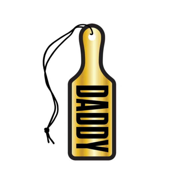 A black string suspends a gold paddle-shaped tag adorned with the bold black word DADDY, reminiscent of a quirky Wood Rocket-Air Freshener-Daddy Paddle. Its minimalist design stands out against a white background, akin to the unexpected delight of a soft 