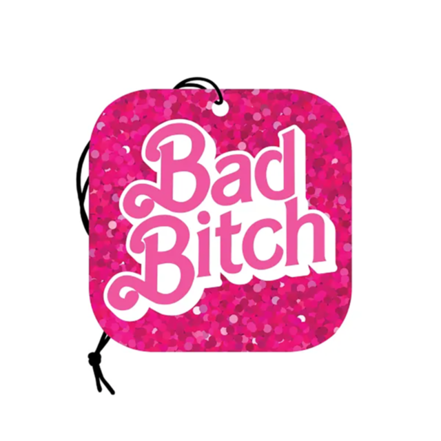 The "Wood Rocket-Air Freshener-Bad Bitch" features a square design with a vibrant pink glitter pattern and bold white text reading "Bad Bitch" in the center. This air freshener exudes a delightful strawberry scent and includes a black string for convenien