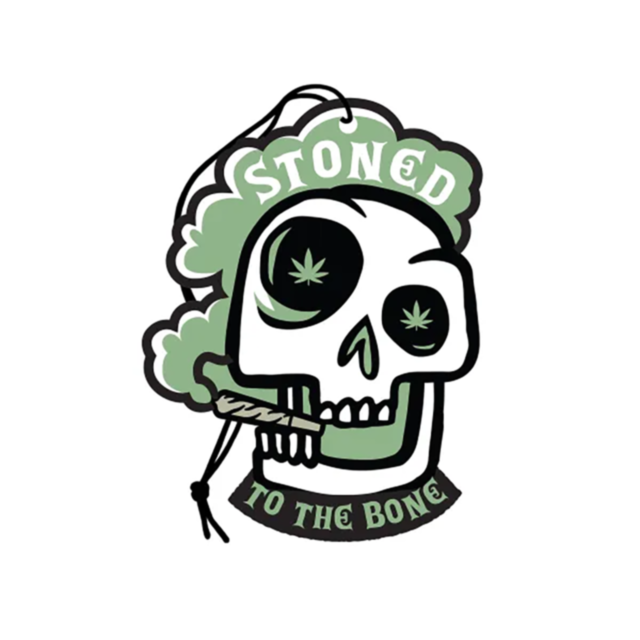 The product "Wood Rocket-Air Freshener-Stoned To The Bone" showcases a fun and daring design of a cartoon skull with marijuana leaf eyes, exhaling smoke that spells out "Stoned to the Bone." This air freshener comes in vibrant green and black colors and e