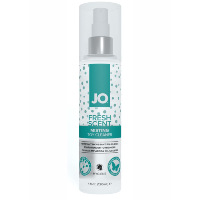 A tree with vibrant green leaves, layered with fluffy white snow, under a blue sky. Much like the gentle refreshment offered by Jo Misting Cleaner 4oz on cherished toys, the transition between winter and spring is beautifully showcased in the contrast bet