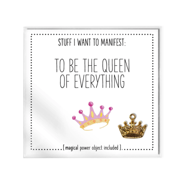 The "To Be The Queen Of Everything Card w Charm" is a decorative print styled like a Manifesting Card, featuring the text "Stuff I Want to Manifest: To Be the Queen of Everything," along with illustrations of two crowns—one pink and one gold. Included at 