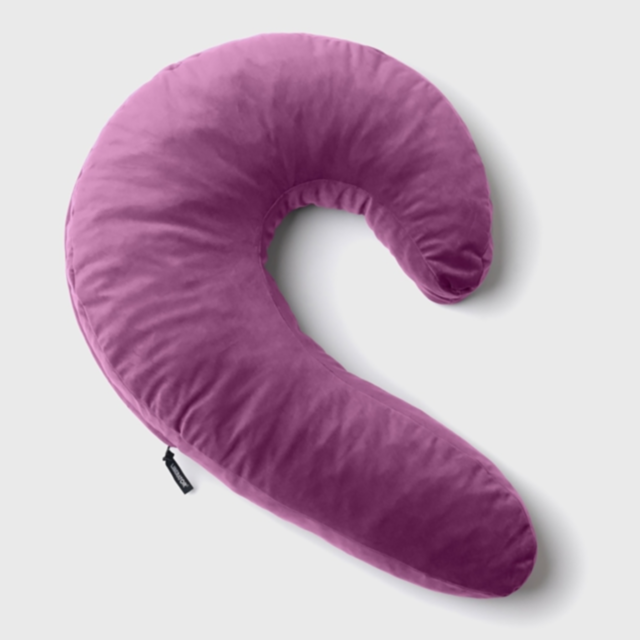 The Lune Side Snuggler Pillow-Purple is a C-shaped pillow made with shredded memory foam, ideal for side sleepers looking for outstanding neck and body support against a pristine white backdrop.