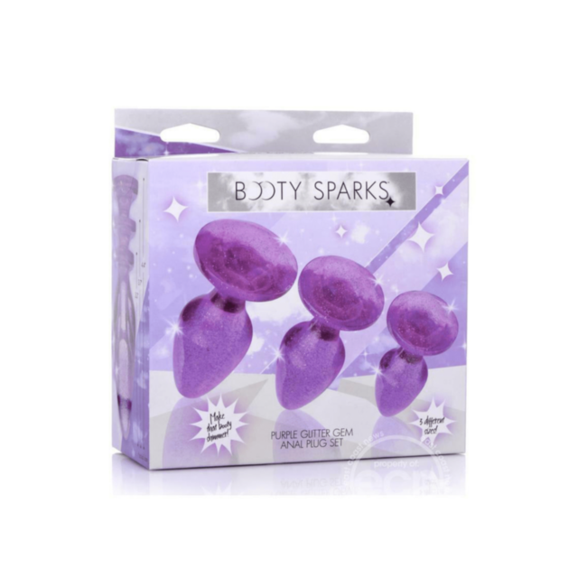 A turquoise fish with long, flowing fins and tail, shimmering like the purple Booty Sparks Glitter Anal Plug Set, swims gracefully in clear water against a deep blue background.