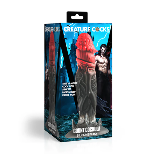 The packaging for the XR-Creature Cocks Sil Count Cockula Dildo is Dracula-themed, highlighting its phthalate-free silicone material. It includes an image of the dildo accompanied by a striking vampire character in the background.