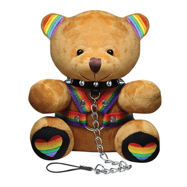 The XR-Bondage Bears Pride Bear Plushie sports a black spiked collar, rainbow harness, and chain leash. Rainbow hearts on its paws and stripes on its ears show LGBTQ+ pride in this playful, unique plush collectible.