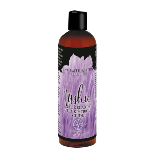 A 120 ml (4 fl. oz.) bottle of TUSHIE 4OZ HYBRID ANAL RELAX GLIDE with a relaxing hybrid formula for comfortable anal play, featuring a purple feather label and a sleek black cap.